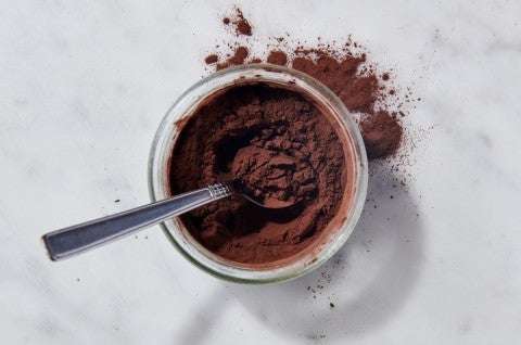 Cocoa powder in a bowl with a spoon